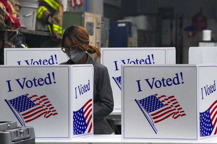 JEENAH MOON / REUTERS
A person votes at Engine Company 15 today in Pittsburgh during the 2024 U.S. presidential election.