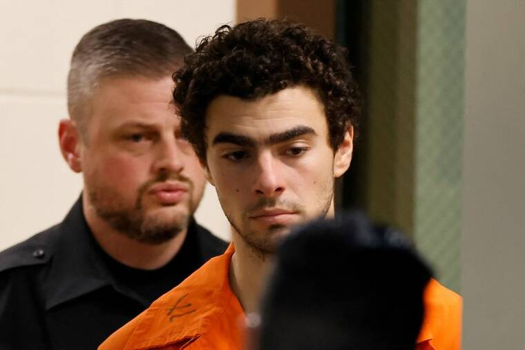 REUTERS/EDUARDO MUNOZ/FILE PHOTO
Luigi Mangione, 26, a suspect in the New York City killing of UnitedHealth executive Brian Thompson, is escorted after an extradition hearing at Blair County Court House in Hollidaysburg, Penn., on Tuesday.