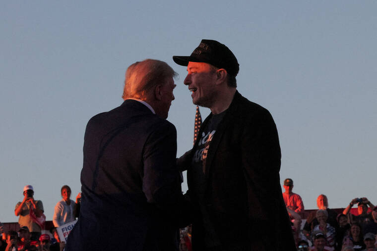 REUTERS/BRIAN SNYDER
Tesla CEO and X owner Elon Musk stands with Republican presidential candidate former President Donald Trump during a campaign rally in Butler, Penn.