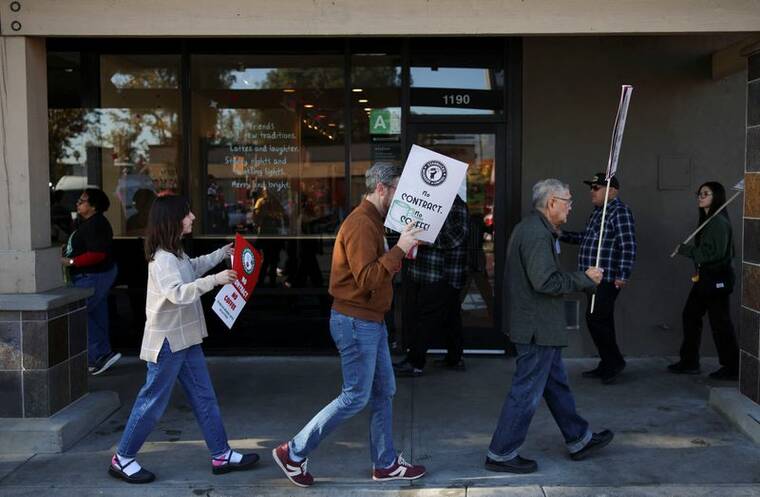 REUTERS/DANIEL COLE
Baristas picket in front of a Starbucks in Burbank, Calif., today.