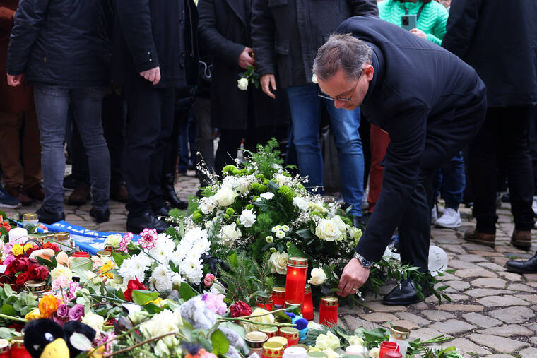 REUTERS/CHRISTIAN MANG
Tino Chrupalla, co-leader of the Alternative for Germany party (AfD), leaves a floral tribute during a visit to the site where a car drove into a crowd of a Christmas market in Magdeburg, Germany.