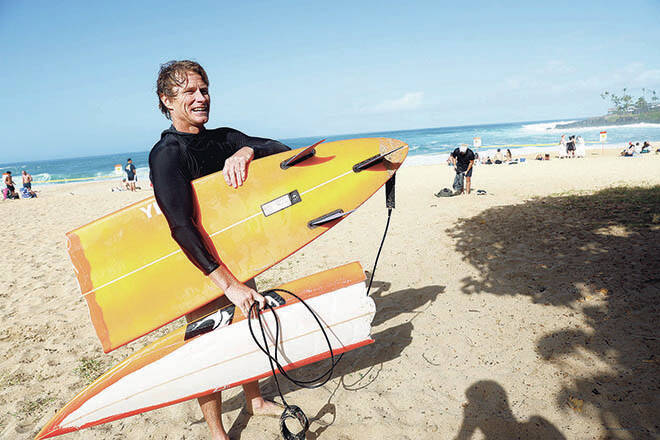JAMM AQUINO / JAQUINO@STARADVERTISER.COM
Professional surfer Mark Healey comes ashore with a broken board while surfing Waimea Bay on Friday.