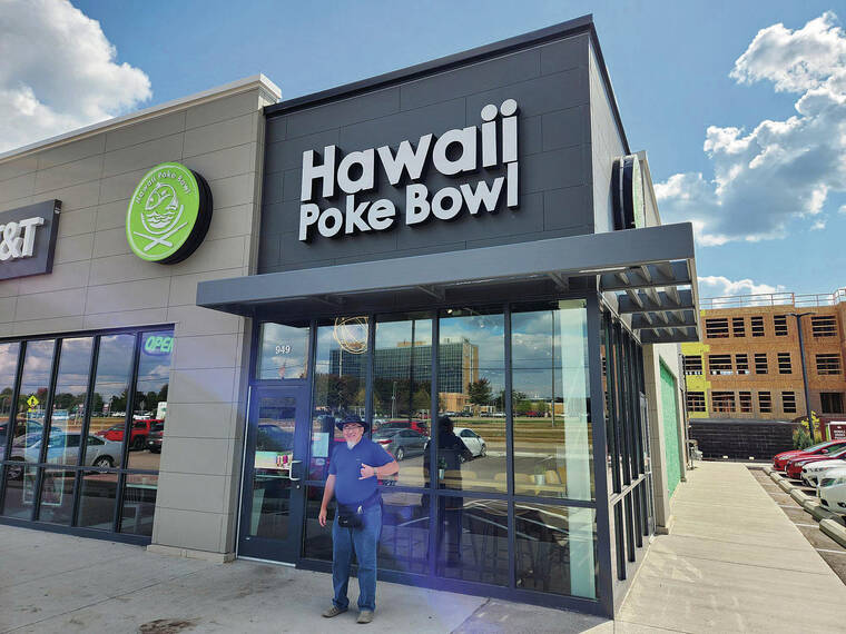 Timothy Inouye was driving through Eau Claire, Wis., with his buddy Warren Chang when they came upon Hawaii Poke Bowl. Chang was inspired to pose for a picture, which was shot by Inouye.